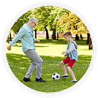 Man and kid playing soccer